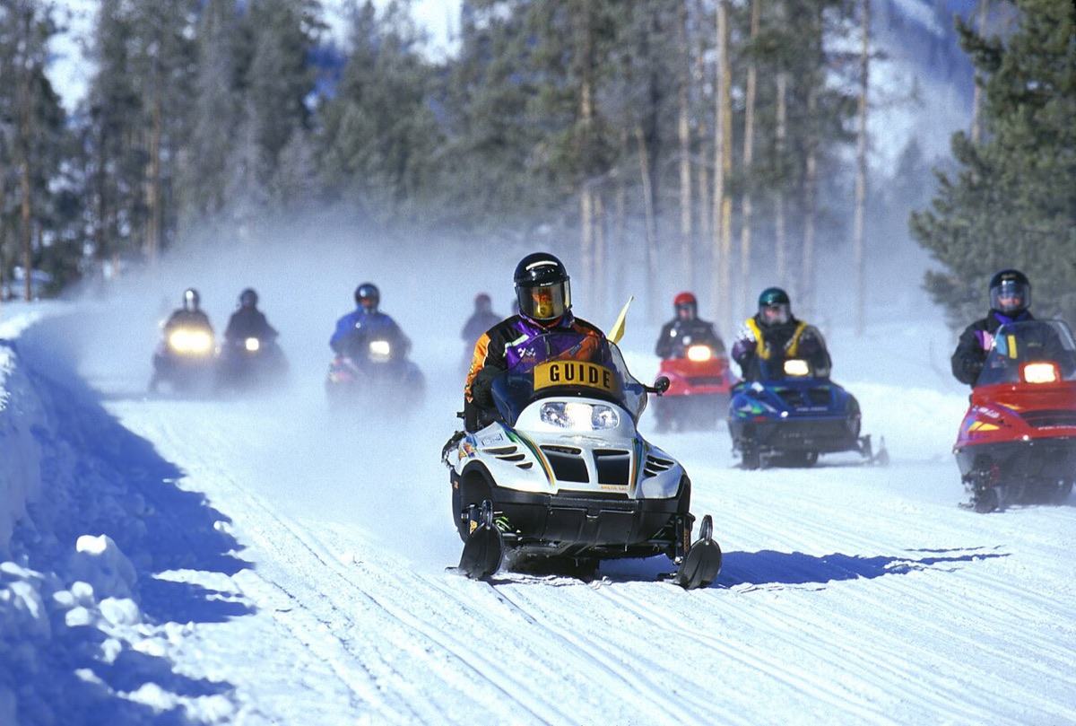 Snowmobiles on a groomed trail in Yellowstone National Park